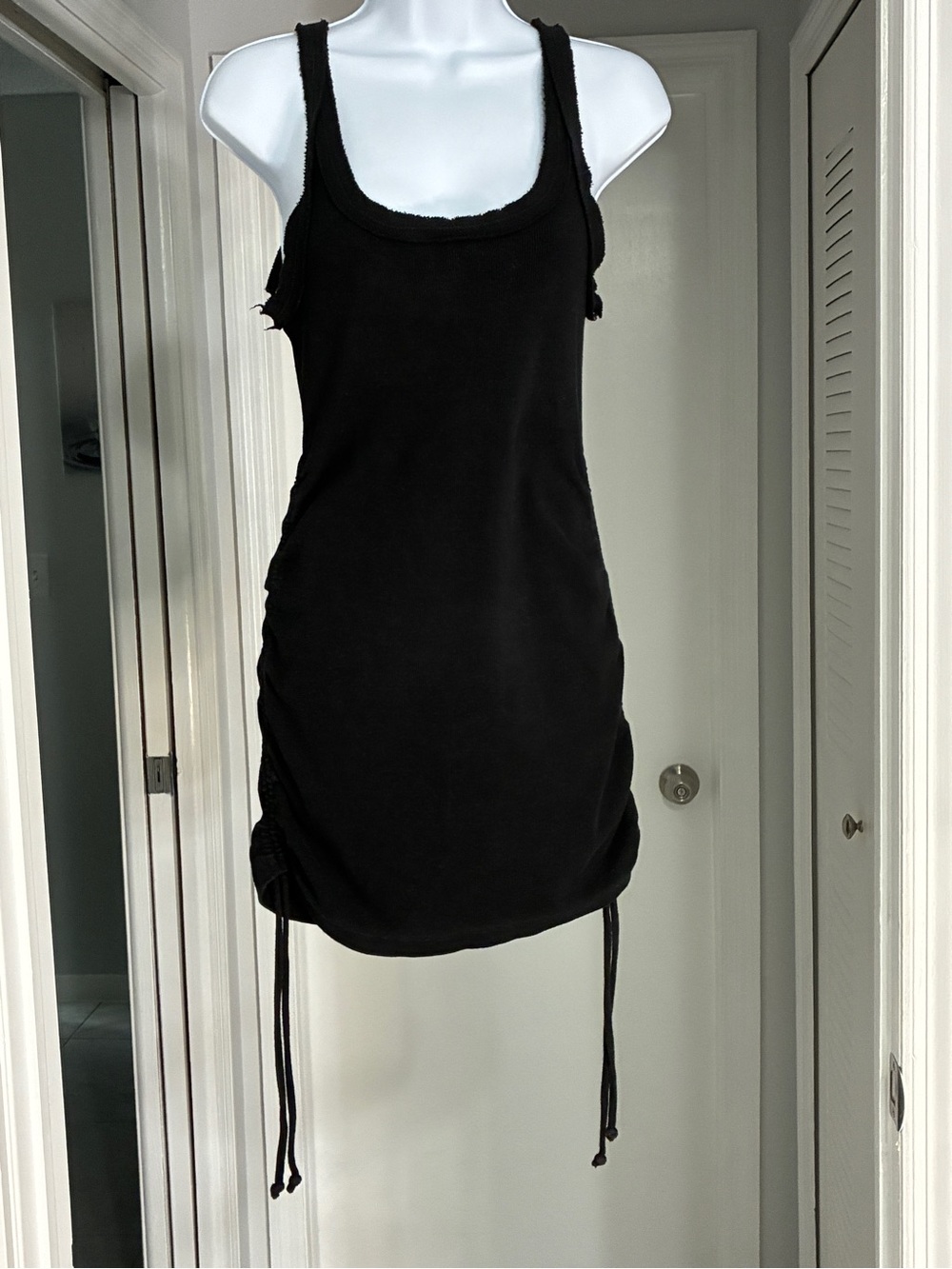 Andi Bagus, hand crafted Womenโs Black Tank Mini Dress with Adjustable Side Ties